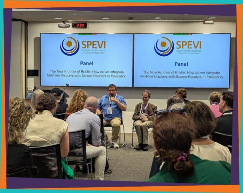 Mick sitting next to Ben Clare at the SPEVI Panel discussion on "The New Frontier of Braille"